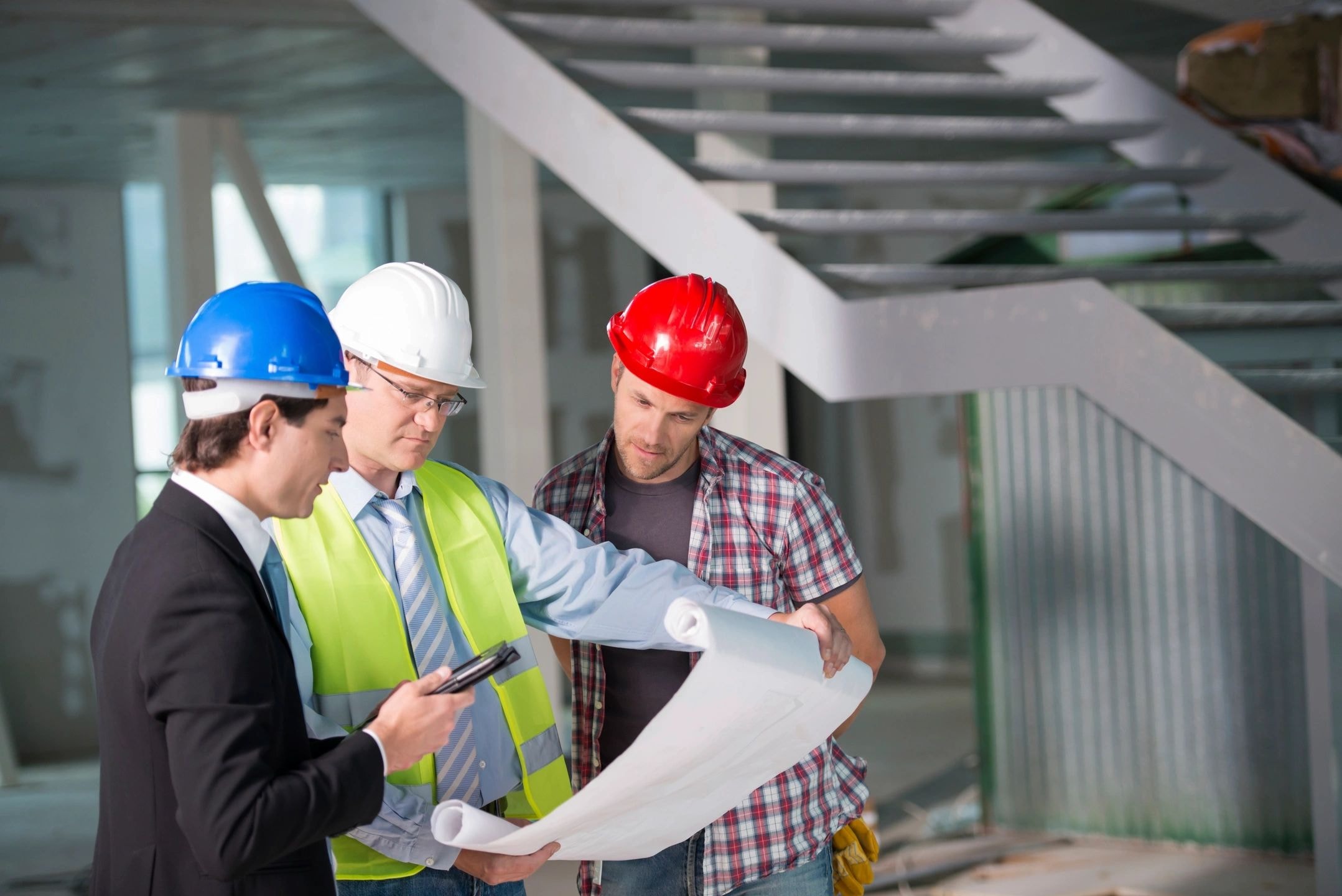 Construction professionals reviewing blueprints